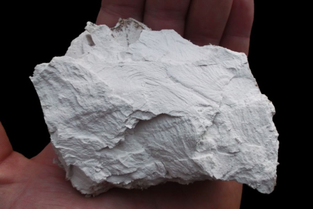 A man holding a Kaolinite crystal